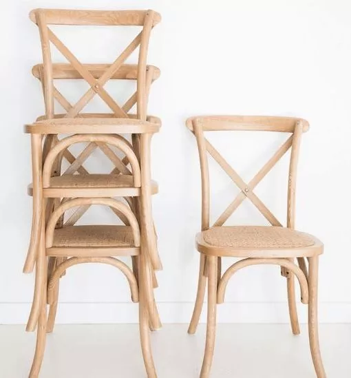 Stackable Crossback chairs stacked on top of each other